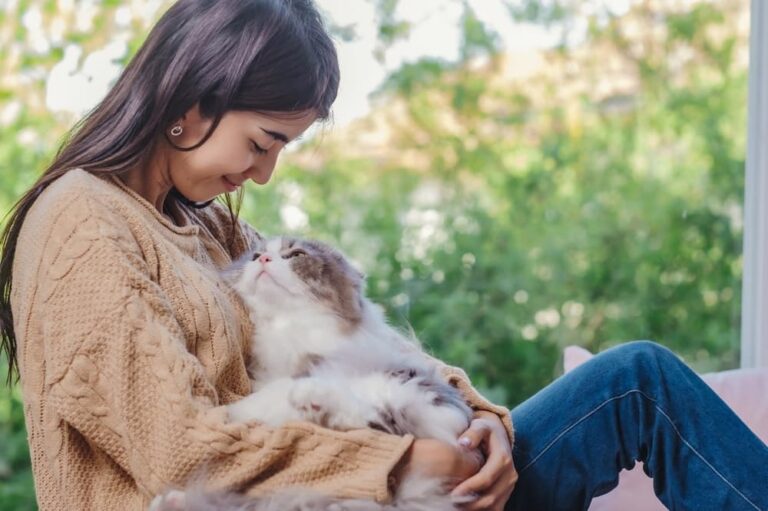 Woman holding cat in lap