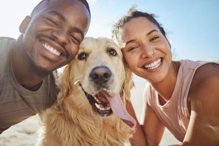 Couple smiling with Golden Retriever